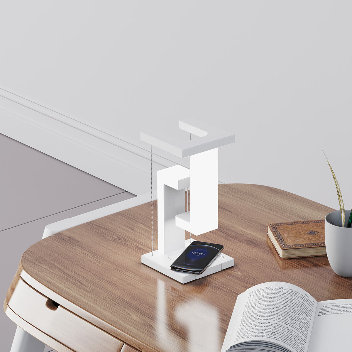 Lampe de bureau blanche au design géométrique, avec smartphone posé sur son socle de charge sans fil
